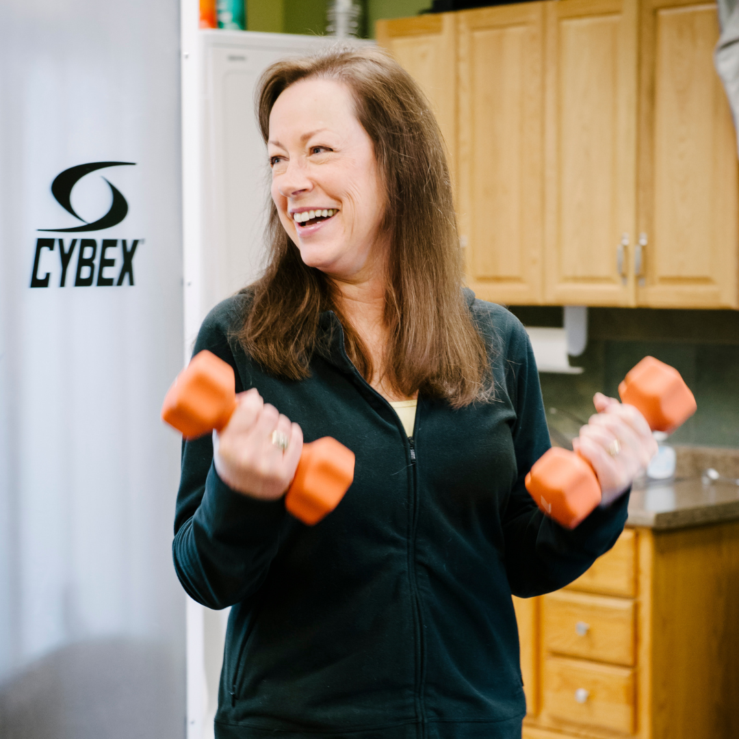 A resilient cancer patient finds joy in working out, lifting small weights as part of their recovery journey.